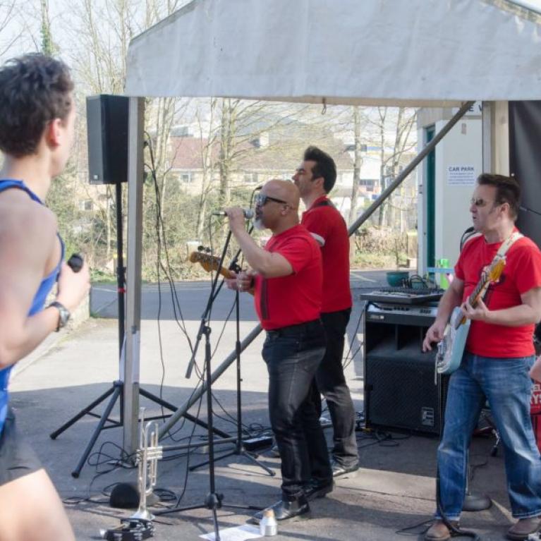 Someone running past a live band