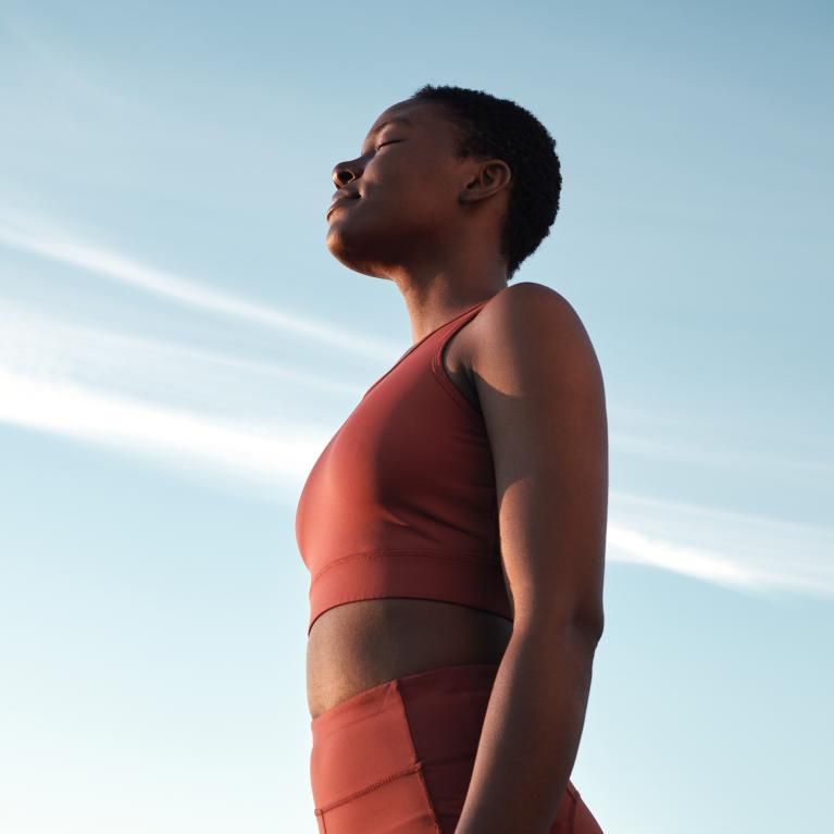 A woman training outside under blue skies