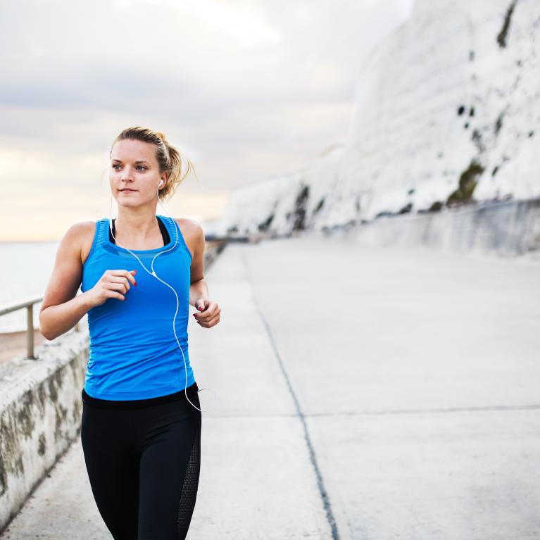 Woman running along the seafront in Brighton