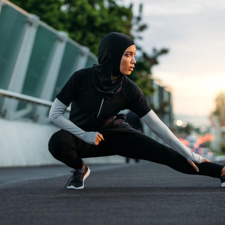 Woman stretching on a bridge before exercising