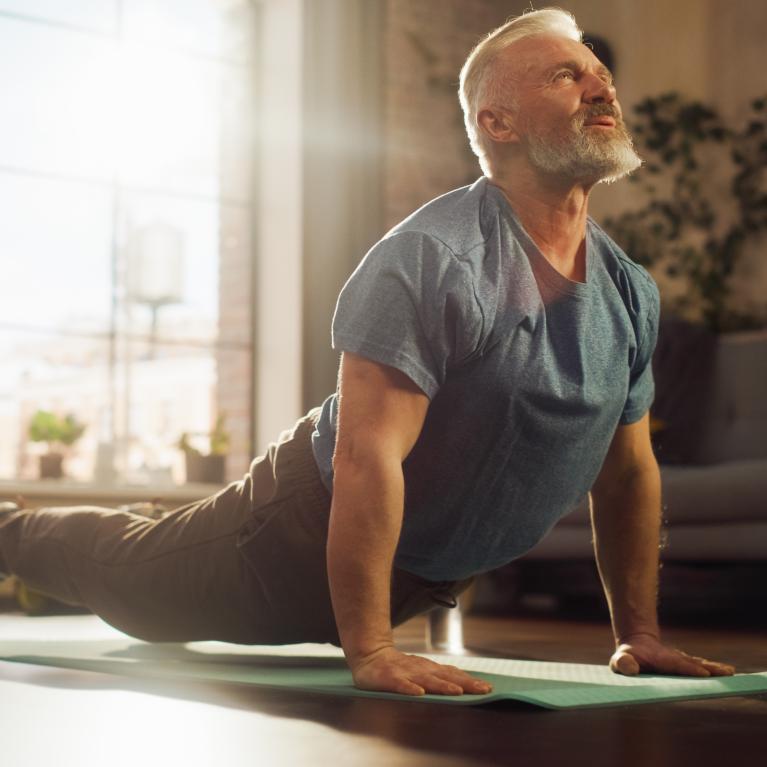 Man stretching in his front room