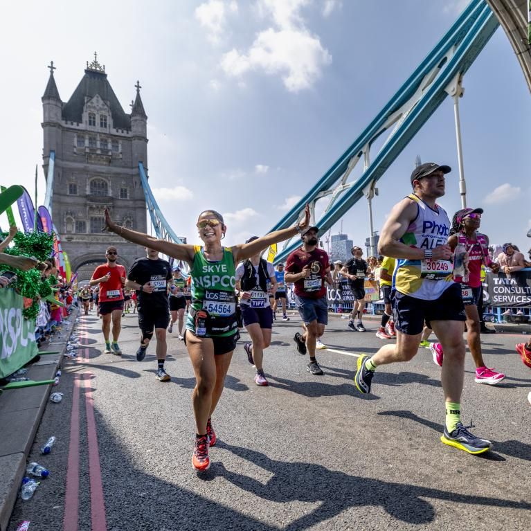 Participants running across Tower Bridge