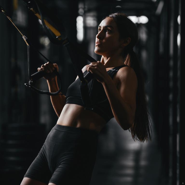 Woman TRX training in the gym
