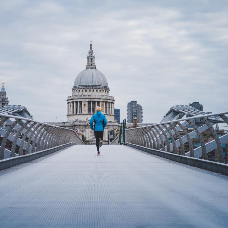 Runner crossing the Millennium Bridge