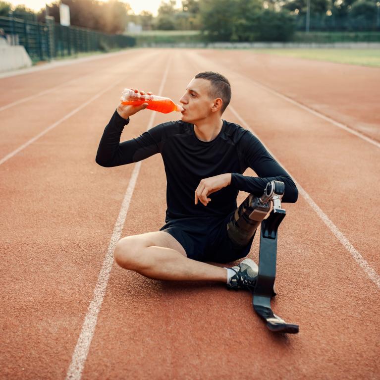 Adaptive athlete sits down to have a drink