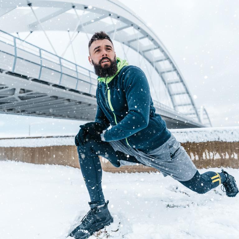 Runner training during winter out in the snow