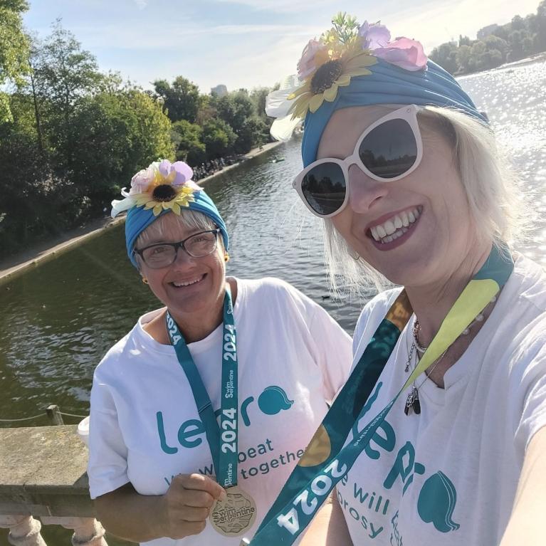 Deryn Martin and Sami Hope pose with their Swim Serpentine medals 