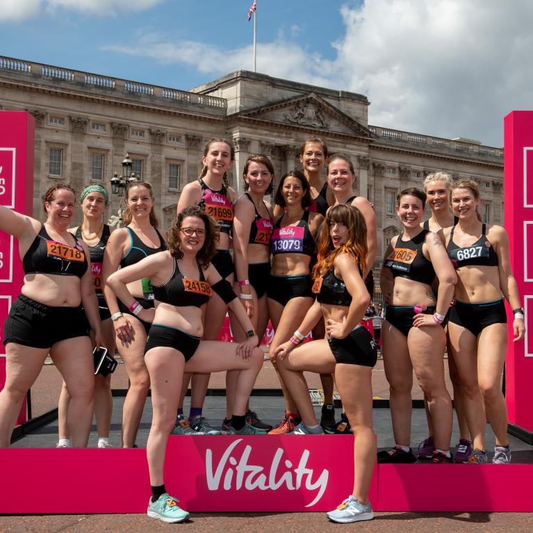 The Celebrate You Campaign group of runners pose for a picture on the podium outside Buckingham Palace