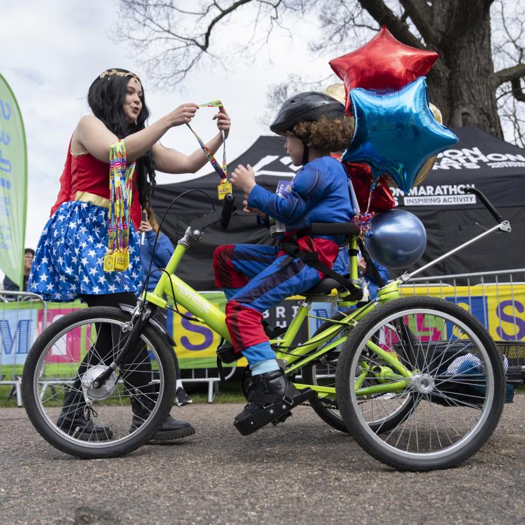 A child receives their medal at the Finish Line