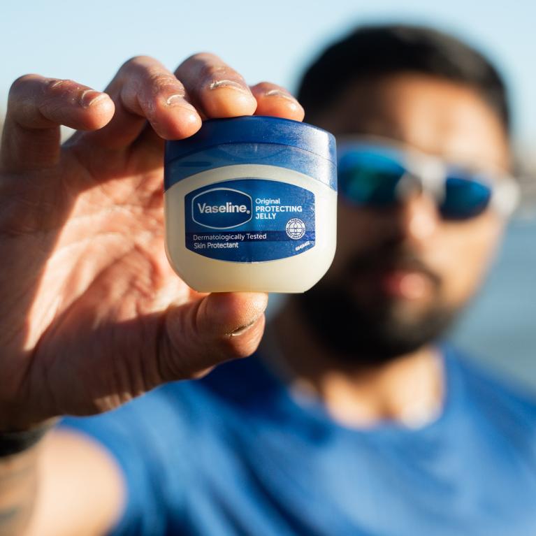 Runner holds up a mini tub of Vaseline