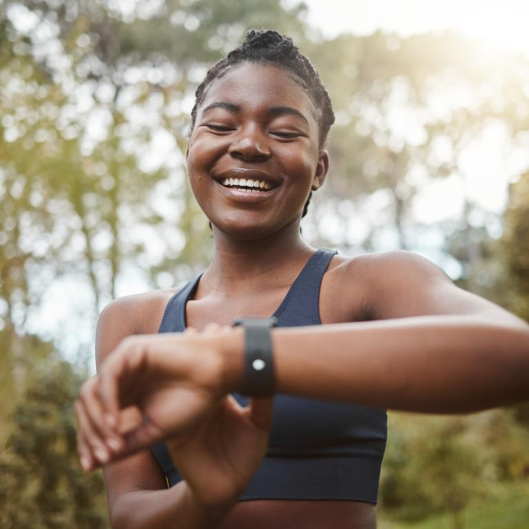 A runner glances down at their running watch 