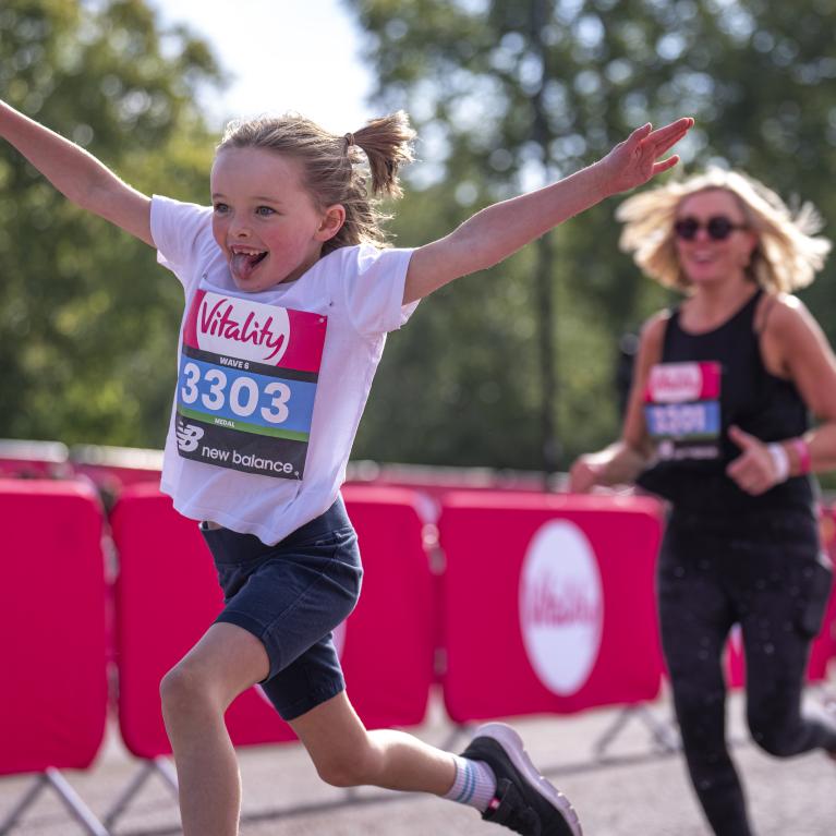 Vitality Westminster Mile runner throws out their arms 