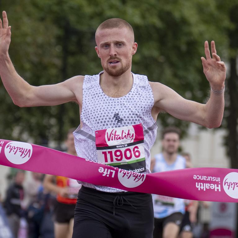 Joe Wigfield celebrates crossing the finish line on the Mall in first place during the British Milers Club Bannister Mile 