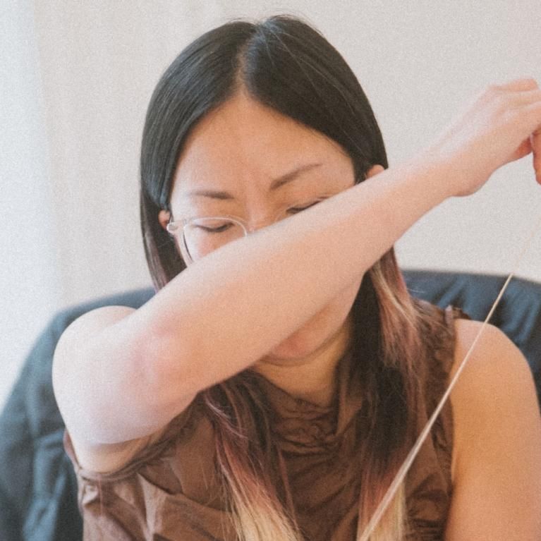 Nicole Chui stitching a bespoke piece 