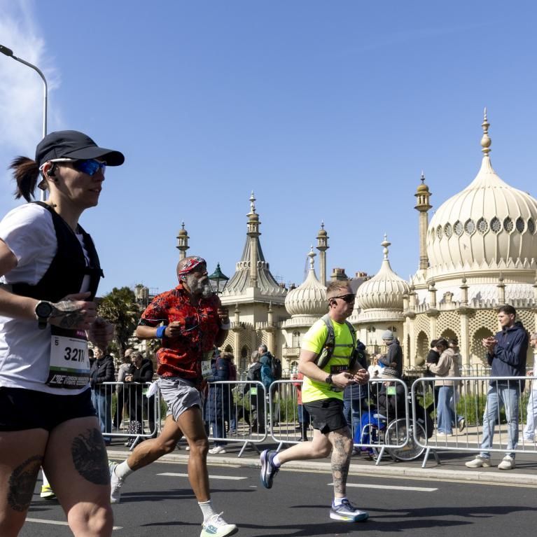 Runners pass the Brighton Dome
