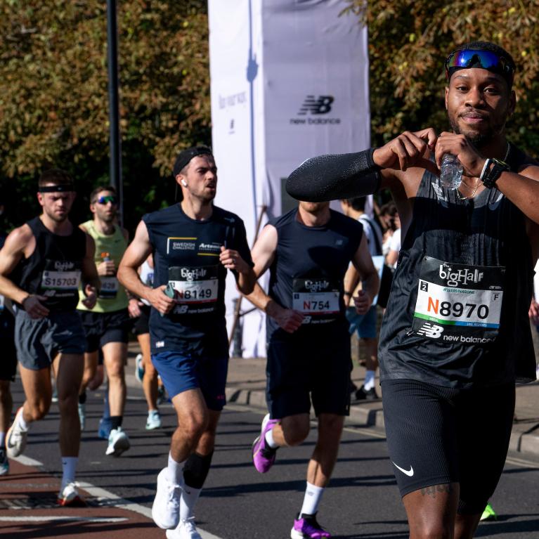 Runner makes heart shape with hands 