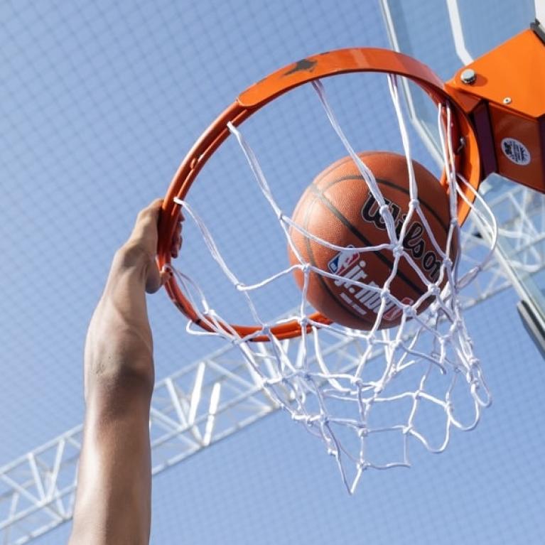 player goes for a slam dunk at Jr. NBA 3v3