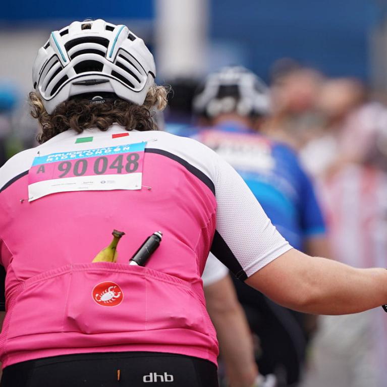 Riders giving high fives to spectators as they pass through during The RideLondon Sportives.