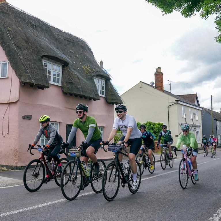Riders cycle through a village in Essex