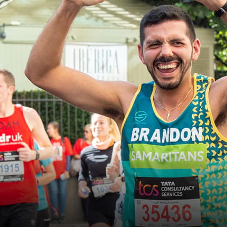 Samaritans charity runner celebrating at the TCS London Marathon