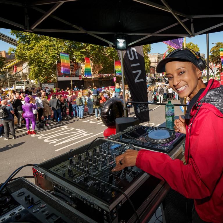 Adele Roberts DJing on stage at Rainbow Row