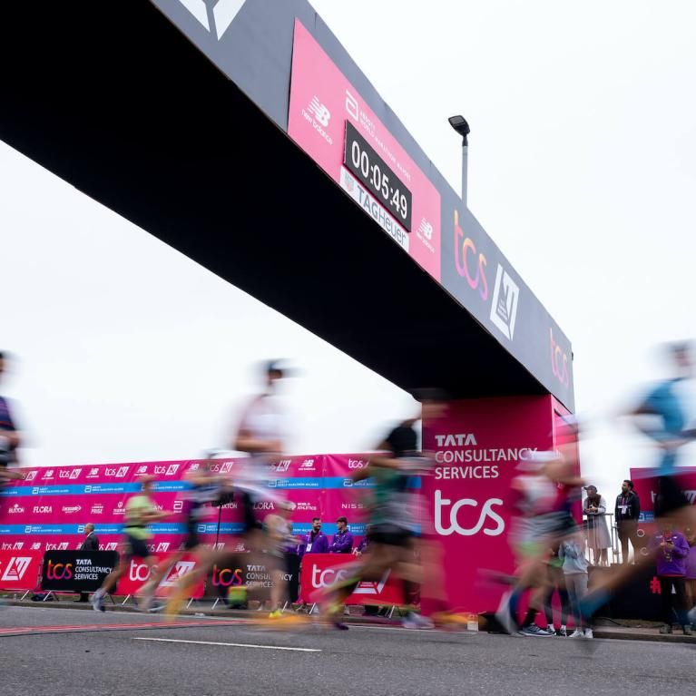A blur of participants crossing the Start Line