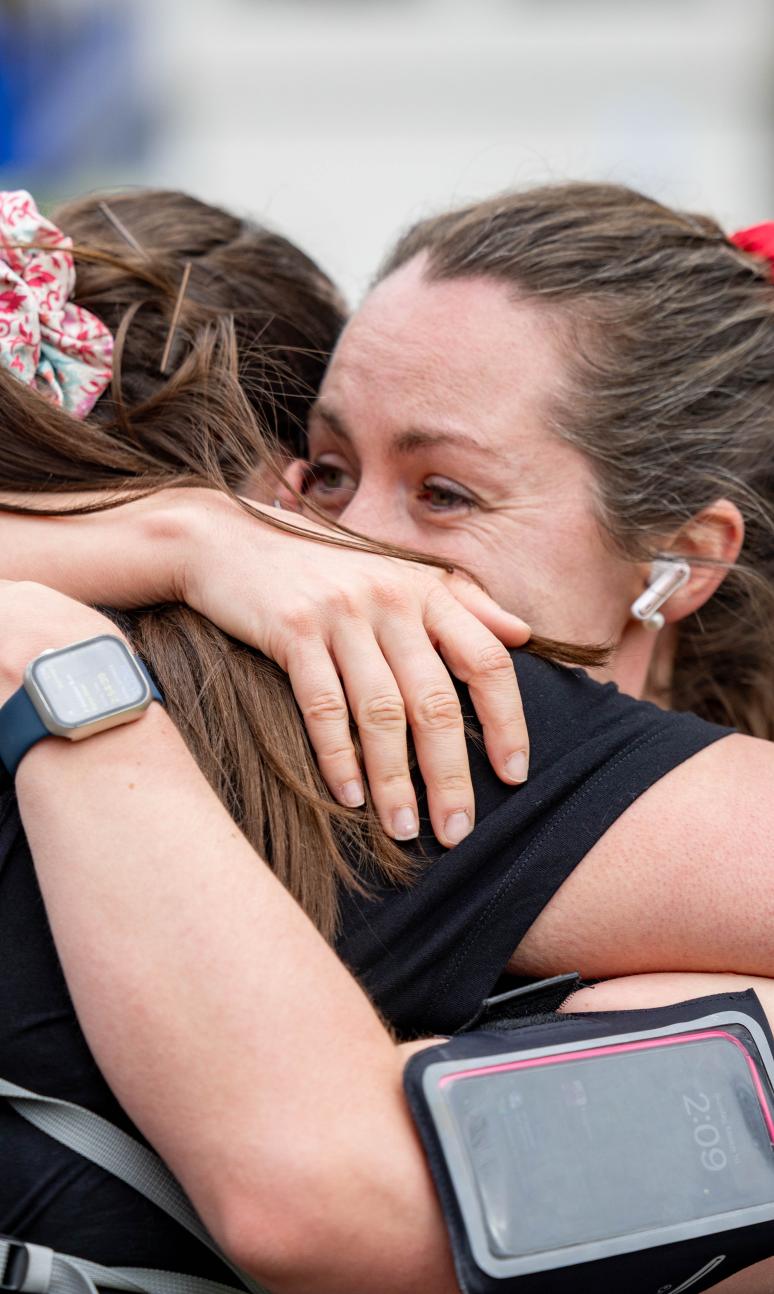 Participants hug each other