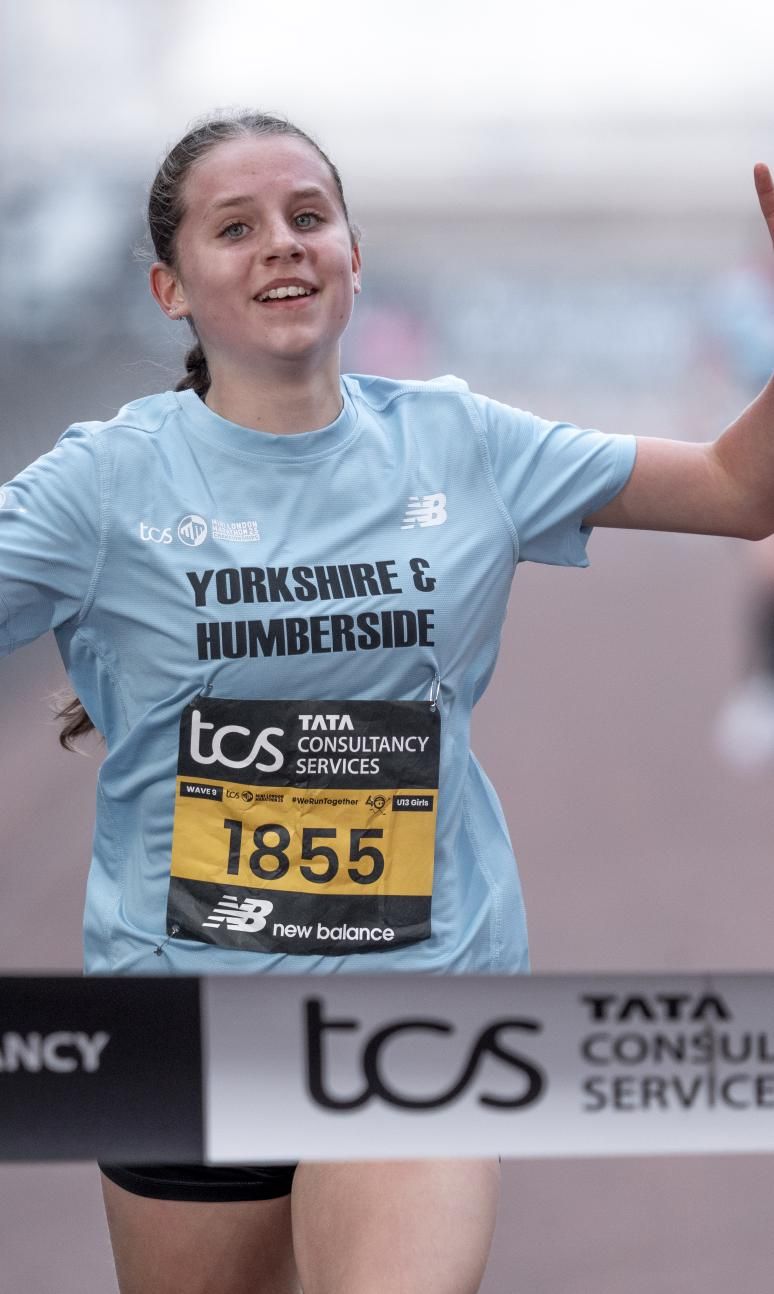 Jessica Thake celebrates as she crosses the finish line to win the U13 Girls race during the TCS Mini London Marathon Championships 