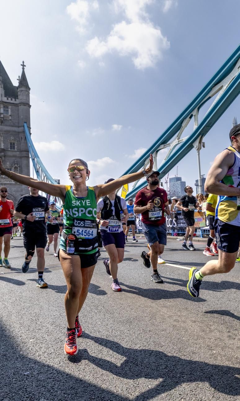 Participants running across Tower Bridge