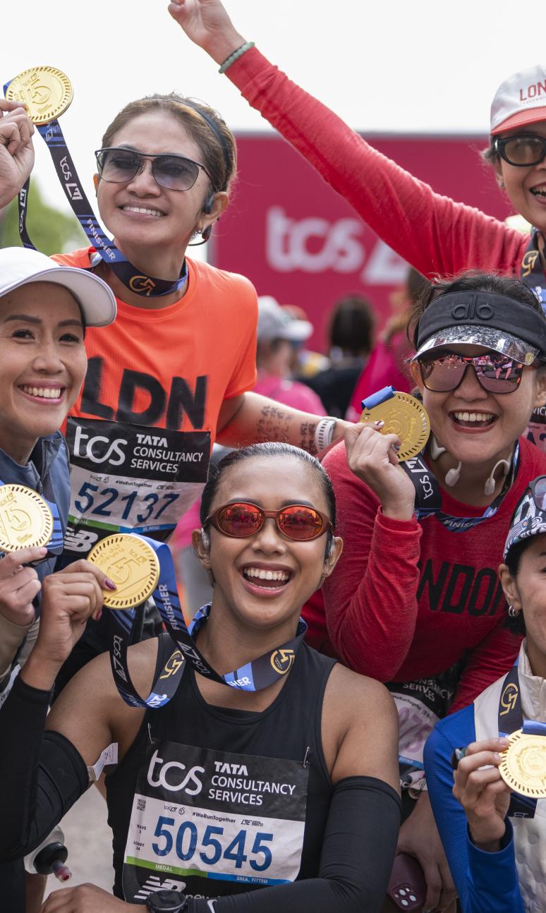 Participants pose at the Finish Line with their medals