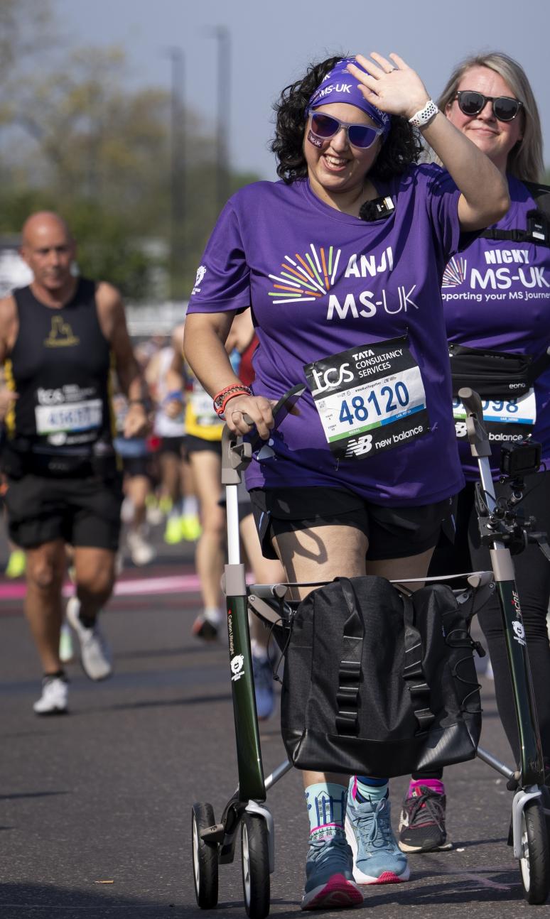 A participant using a frame walker leaves the Start Area