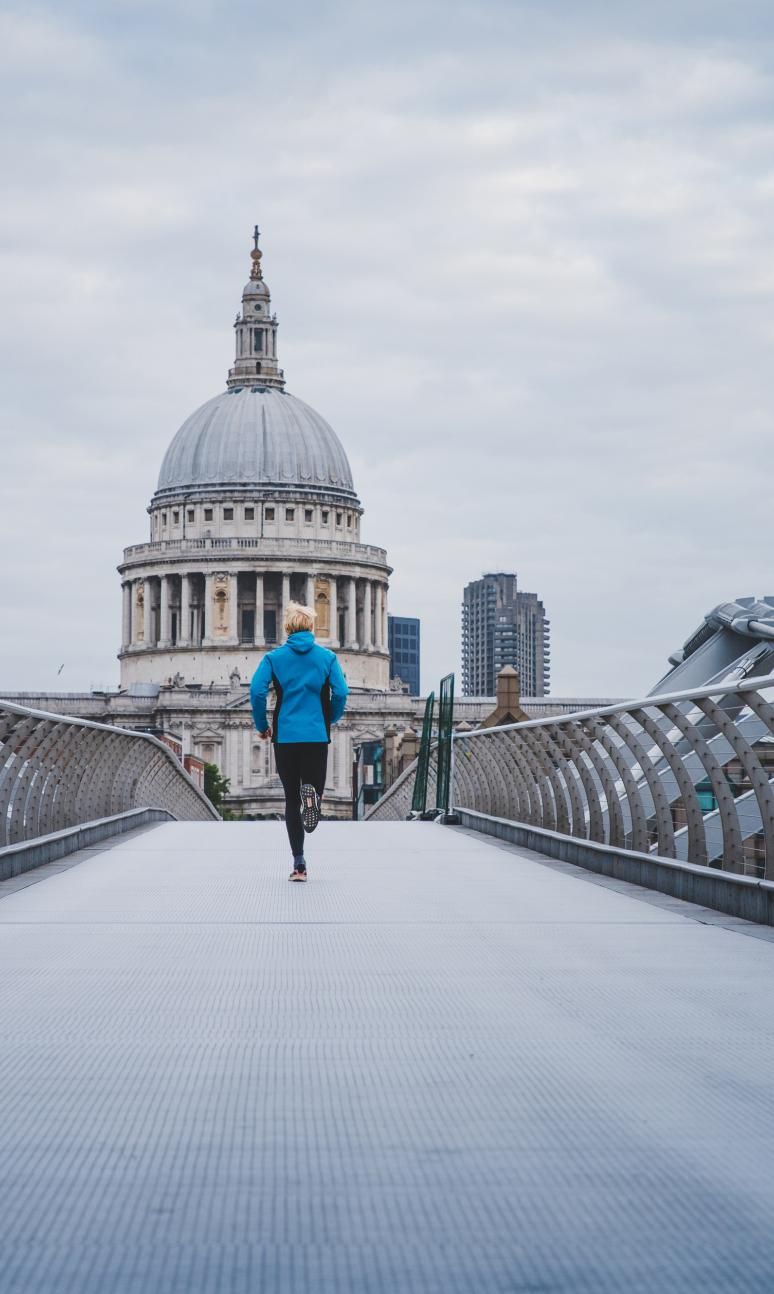 Runner crossing the Millennium Bridge