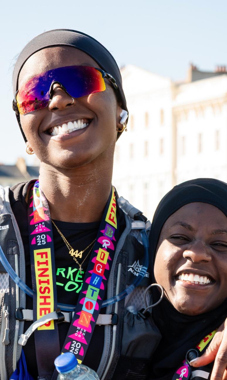 Brighton Marathon finishers pose with their medal