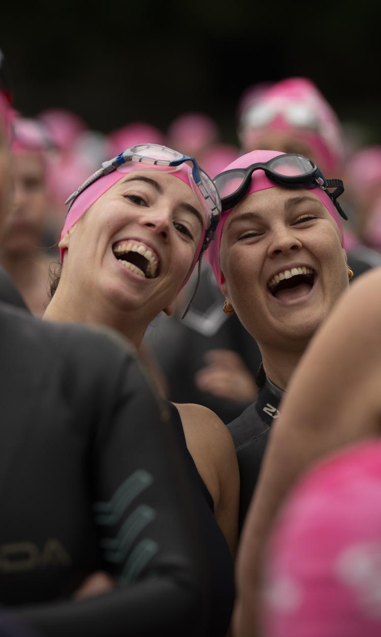 Two swimmers smile in the crowd