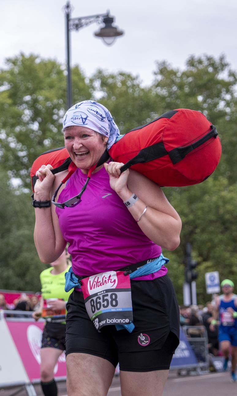 Participants carrying a sandbag approaches the Finish Line