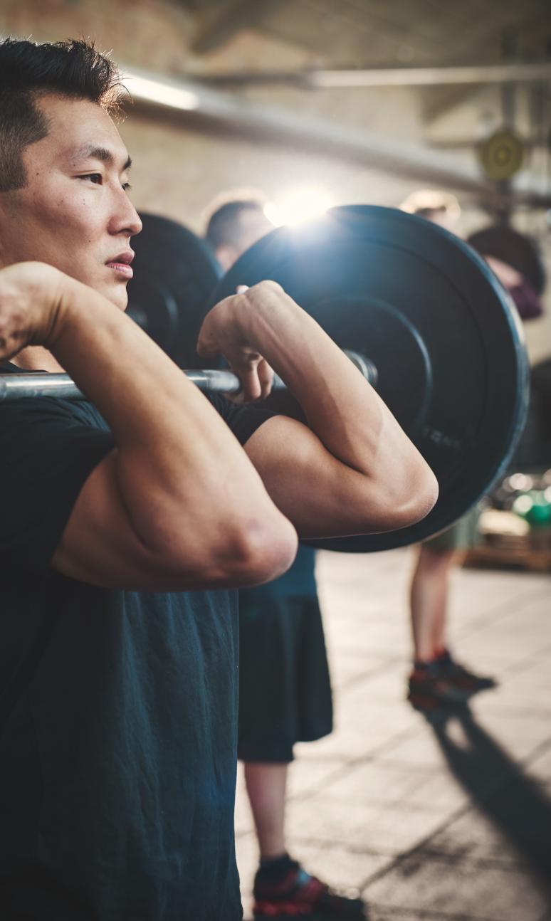 Man with a barbell in front rack