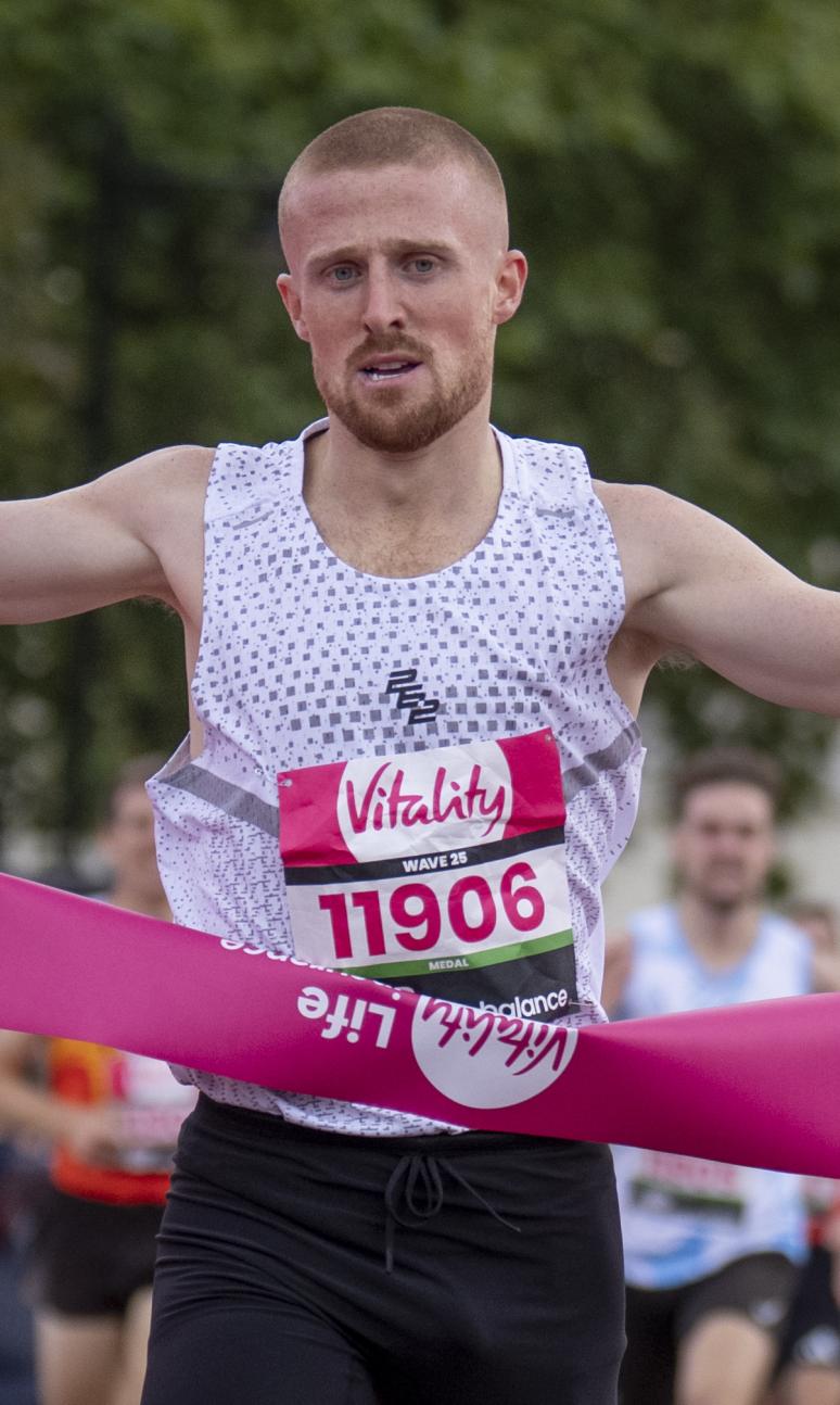 Joe Wigfield celebrates crossing the finish line on the Mall in first place during the British Milers Club Bannister Mile 