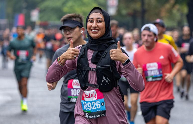 A participant poses for a photo as they run through the City of London during The Vitality London 10,000, Sunday 22nd September 2024.
