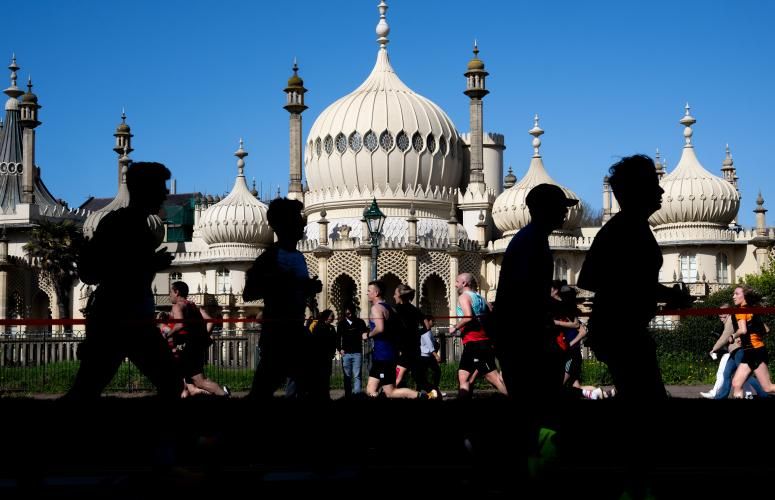 Runners pass the Brighton Royal Pavilion & Garden