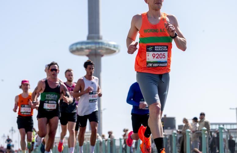 Club runners pass the Brighton i360