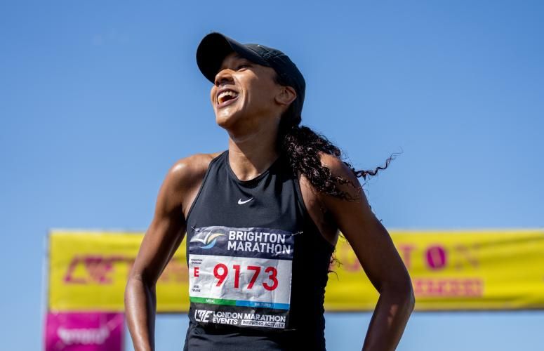 Participant beams with joy at the Finish Line