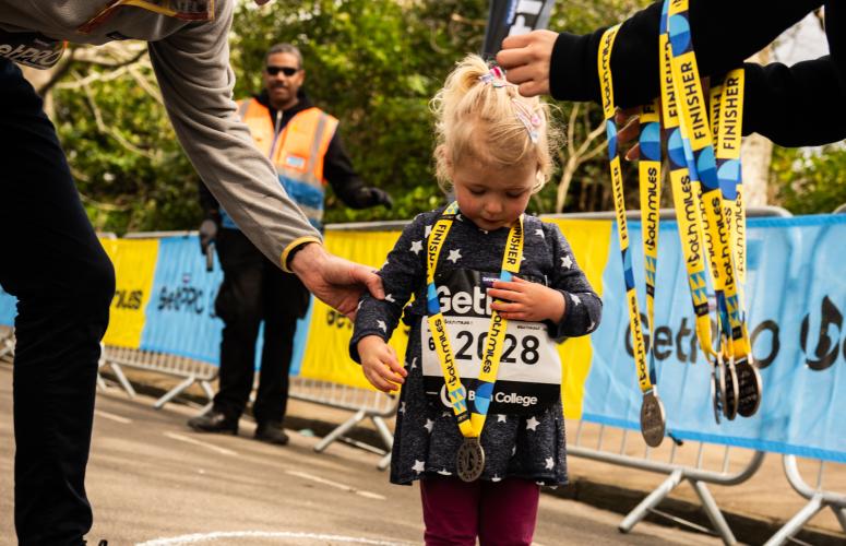 Bath Miles finisher getting their medal