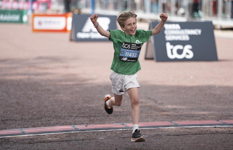 Participant cheering as they cross the Finish Line