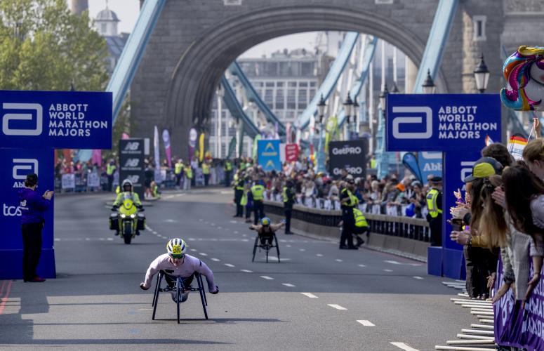 The elite wheelchair race crosses Tower Bridge