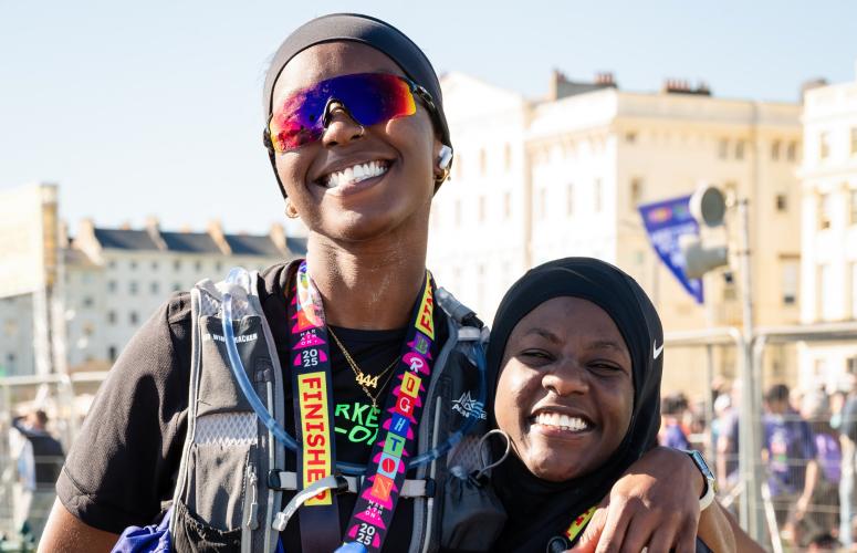 Brighton Marathon finishers pose with their medal