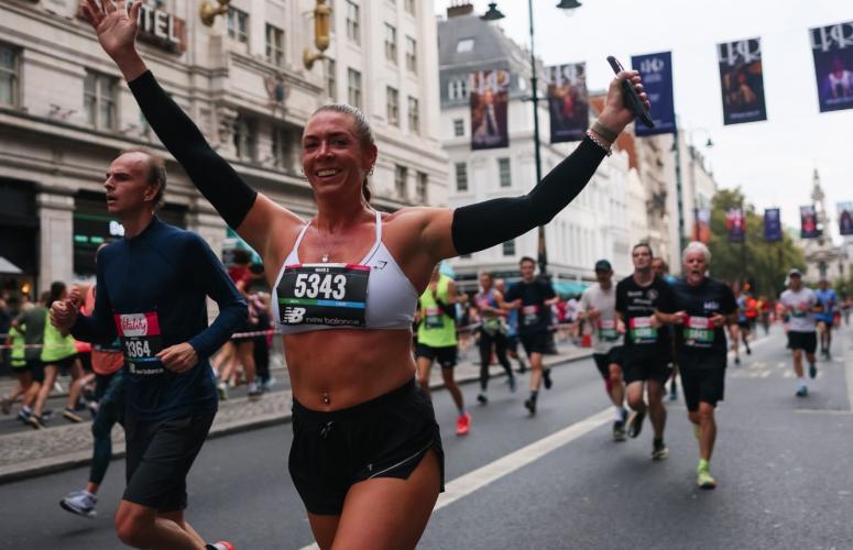 Runners celebrate as they pass through Central London
