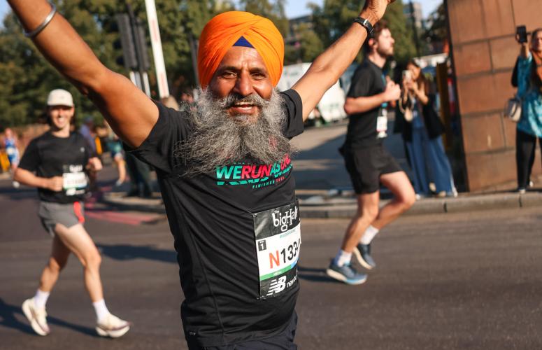 Runner throws his arms up for the camera