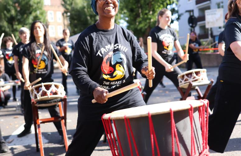 Drummers beaming as they perform for the runners