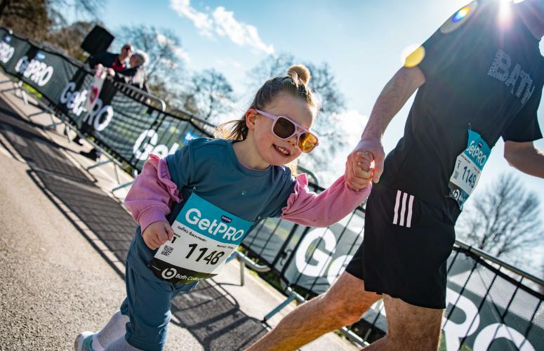 Child holds their care takers hand 
