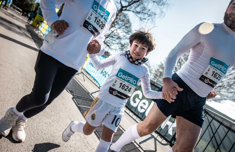 Child runs between two adults 